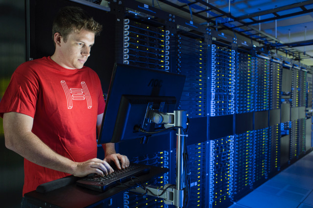 Hivelocity employee working at a computer within a server room