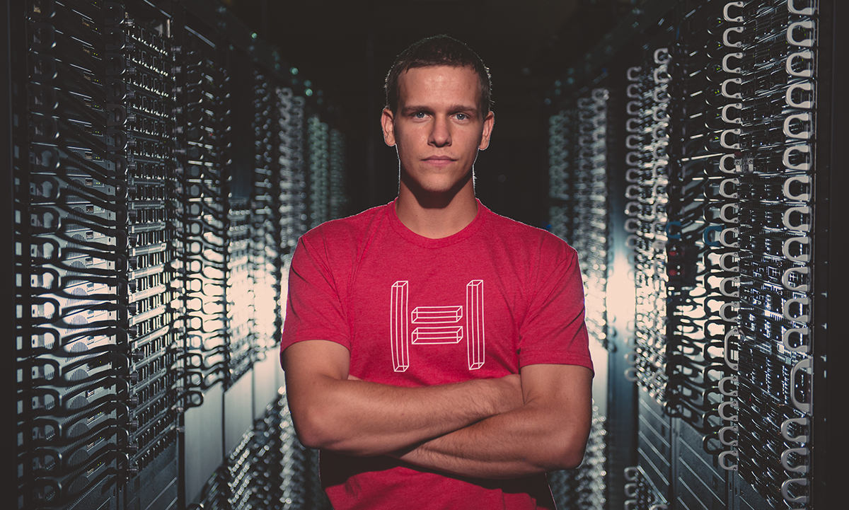 A Hivelocity employee standing in a server room filled with dedicated servers