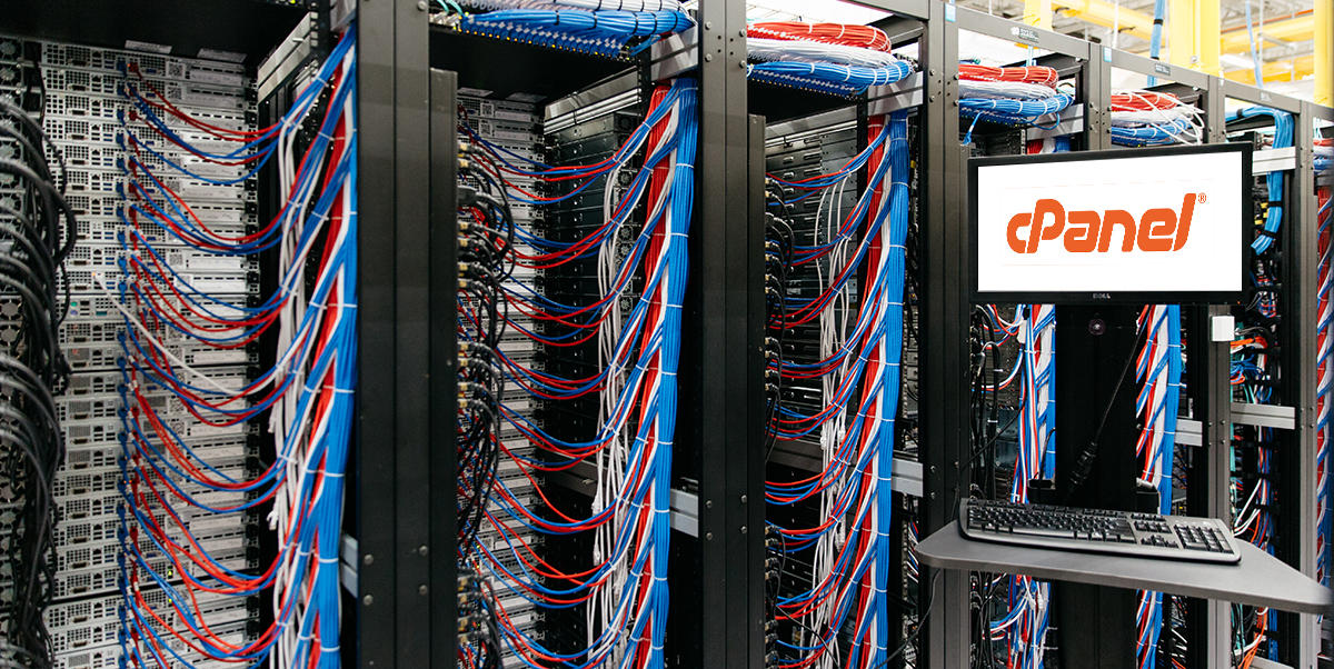 Server cabinets and cables next to computer screen featuring cPanel logo