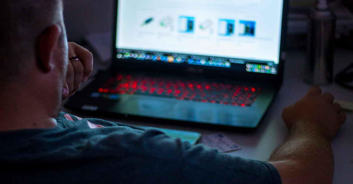 A man sitting in front of a laptop